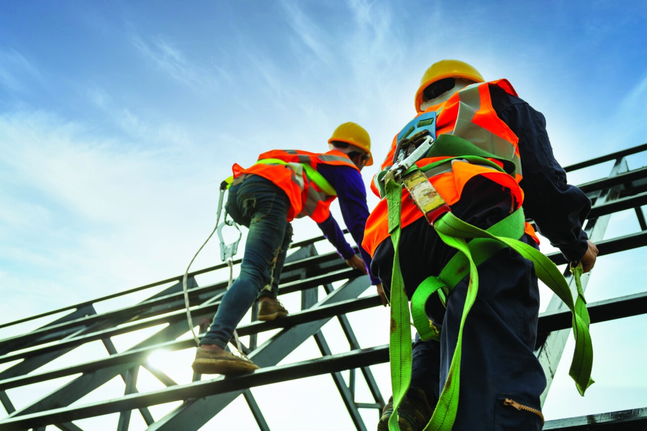 workmen in harnesses working at height