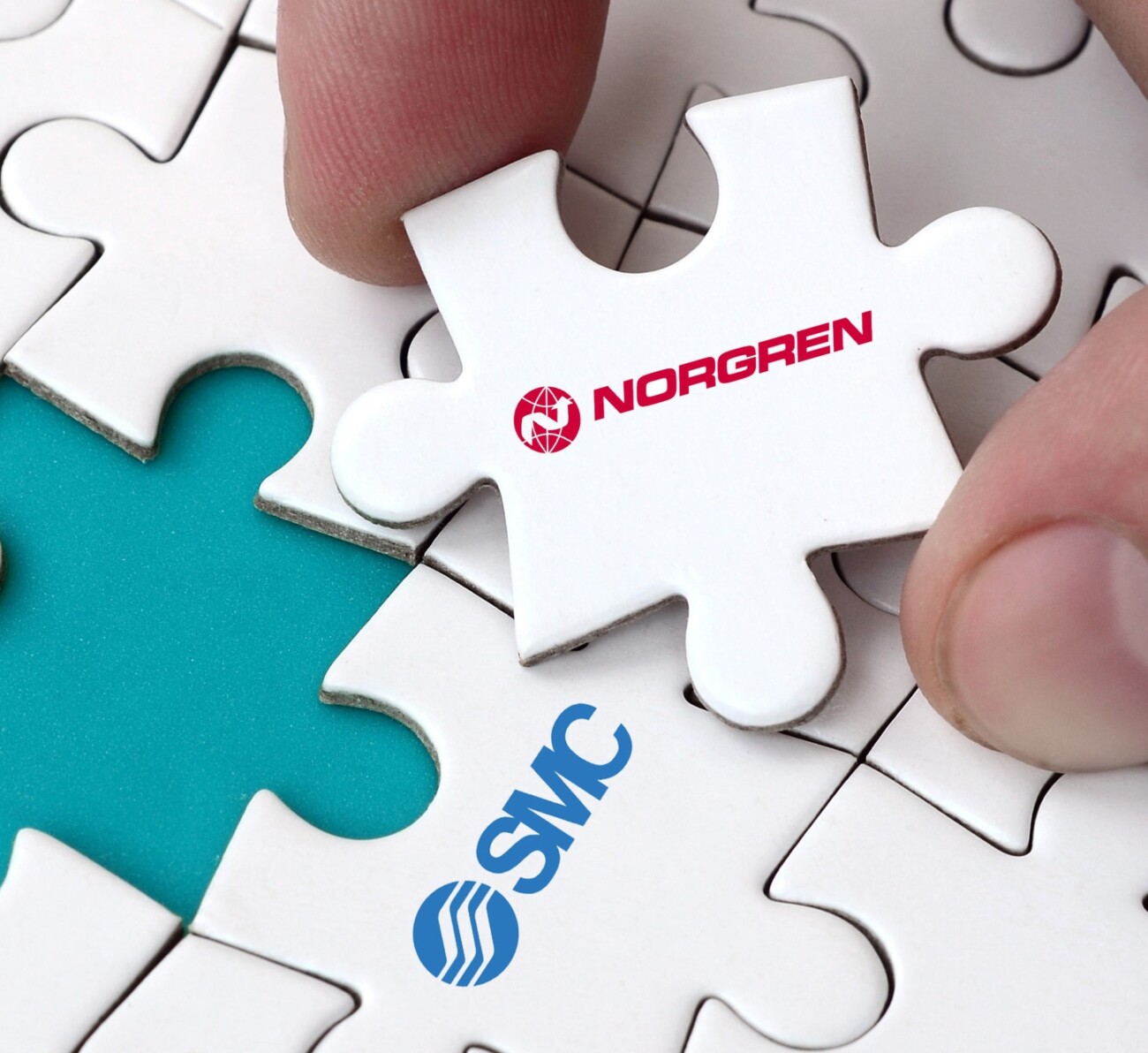 jigsaw puzzle piece with Norgren logo being placed into puzzle