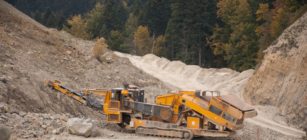 yellow heavy vehicle in quarry setting