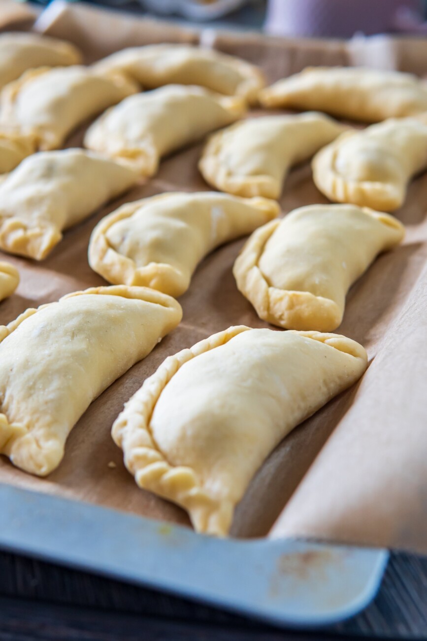 raw pasties on a baking tray ready to be baked